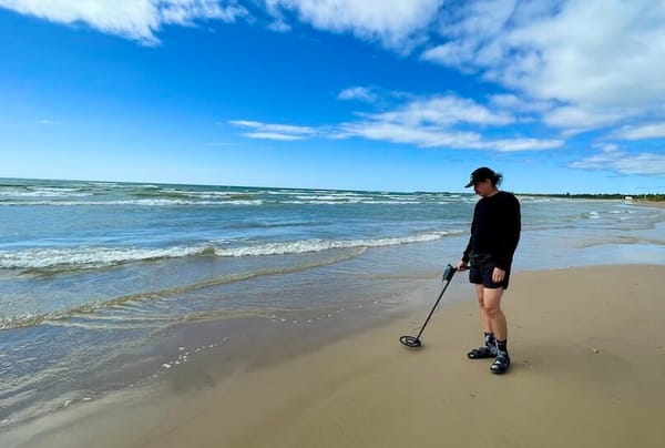 Christopher on the beach, hunting for treasure